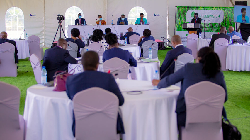 Mr. Gawaya Tegule (standing) moderating a panel session having representatives from Ministry of water and environment, NFA, NEMA, and Civil society.